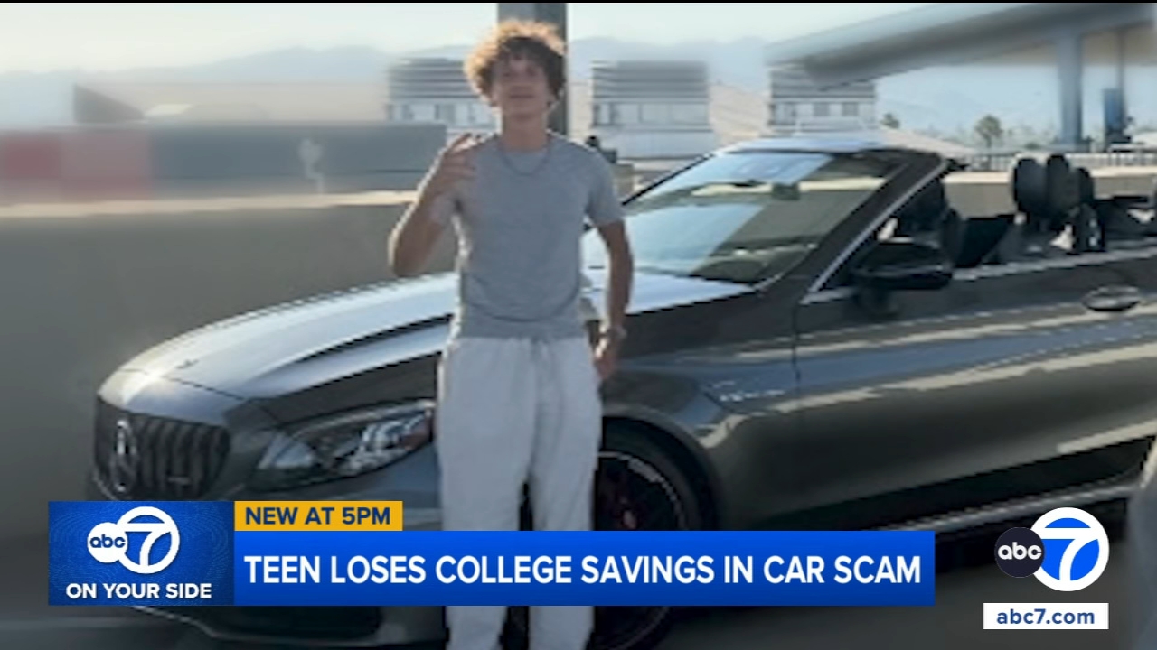 Young man standing outside a coffee shop, looking worried about a car issue.